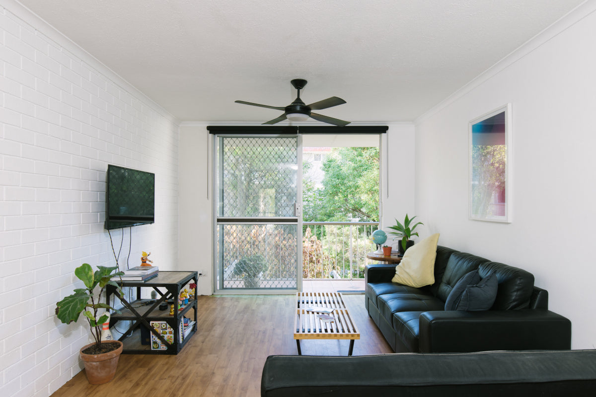 A bright, modern living room featuring a handcrafted wood and metal coffee table, representing Ember and Oak's sustainable home decor available in Manassas, VA.